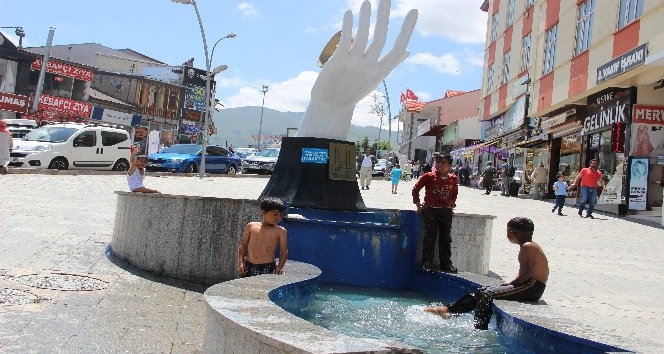 Sıcaktan bunalan çocuklar süs havuzunda serinliyor